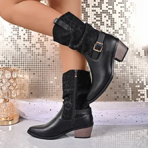Detail of black mid-calf leather boots featuring leopard print shaft and side zipper