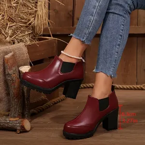 Detailed view of burgundy chunky high heel ankle boots with 8.3cm heel height measure
