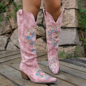 Detail showing floral embroidery on pink V-neck Western cowboy boots with chunky heels
