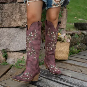 Detailed view of wine red embroidered high-top western cowboy boots with chunky heel