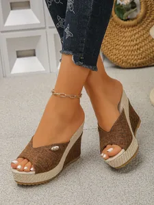 Close-up of stylish brown linen wedge sandals with woven platform and open toe.