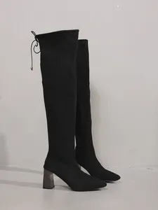 Elegant black suede over-the-knee boots with pointed toe and sturdy block heel.