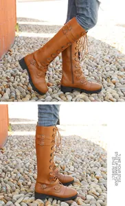 Brown knee-high knight boots with multiple buckle straps and lace-up front detail