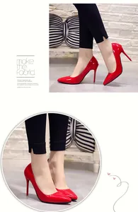 Detailed view of elegant red patent leather pointed-toe stilettos with fine high heels.