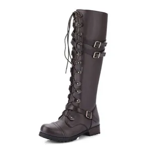 Close-up of brown knee-high riding boots with decorative buckles and laces