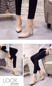 Elegant nude patent leather pointed-toe stilettos with black slim pants styling.