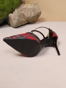 Detailed view of red plaid pointed toe high heel stiletto sandal with black straps