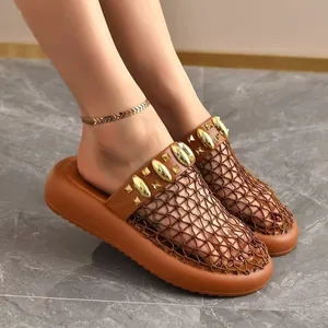 Detailansicht brauner Netz-Clogs mit Goldnieten und Plateau-Sohle