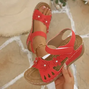 Stylish red retro wedge sandals for women featuring floral accents and hollow cutouts