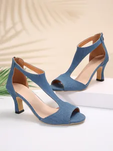 Detailed side view of elegant blue denim peep toe sandals with T-strap and back zipper.