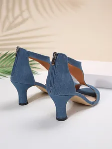 Detailed rear view of blue denim kitten heel sandals featuring back zipper and cut-out sides