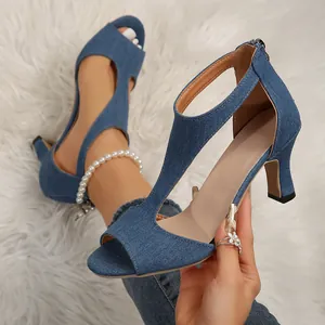 Elegant blue denim T-strap peep-toe sandals featuring kitten heels and a back zipper closure