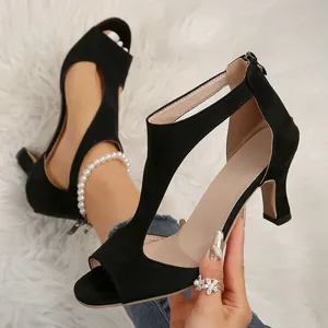 Elegant black suede peep toe high heel sandals featuring hollow T-strap and back zipper closure