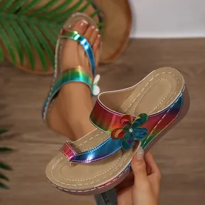 Detail of rainbow holographic wedge sandals with flower decor and comfy thick sole