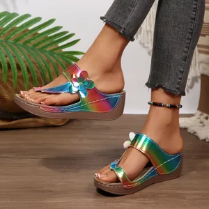Side view of women's rainbow metallic wedge thong sandals featuring floral ornament decoration