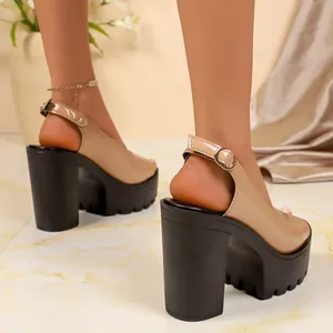 Detailed back view of beige patent leather platform sandals with chunky black heels.