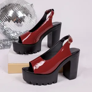 Detailed view of wine red patent leather platform sandals with chunky high heels.