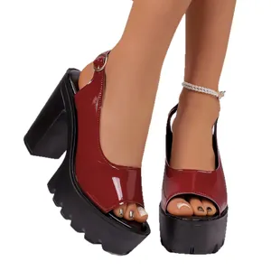 Burgundy patent leather peep-toe sandals with chunky black platform heels and serrated soles.