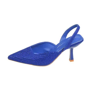 Detail of royal blue pointed toe heels featuring shimmering rhinestone embellishments.