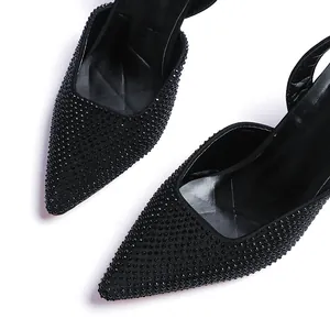 Close-up detail of black rhinestone embellishments on pointed toe high heel sandals