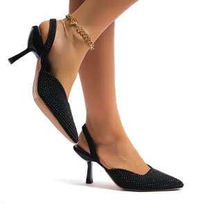 Elegant black pointed-toe rhinestone slingback high heels shown on model's feet.