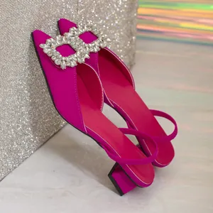 Detail view of fuchsia satin sandals featuring a luxurious square rhinestone buckle.