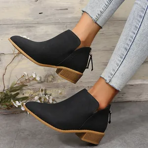 Side cutout black pointed toe ankle boots with decorative rear tassel zipper detail