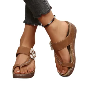 Elegant womens brown wedge sandals with white floral decoration and thick platform soles