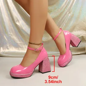 Close-up of pink patent leather Mary Janes with 9cm rhinestone block heel.