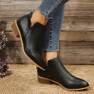 Detailed close-up of black leather pointed toe ankle boots with a low wooden block heel