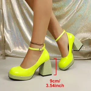 Detail view of neon yellow patent leather Mary Jane shoes with 9cm rhinestone chunky heels.
