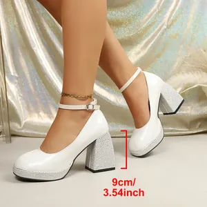 Detail of white patent leather Mary Jane shoes with 9cm rhinestone chunky heels