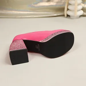 Detail view of pink patent leather platform Mary Jane heels with rhinestone accents