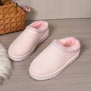 Comfortable pink thick-sole plush snow boot slippers with warm faux fur lining for winter.