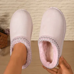 Detail view of pink women's fuzzy slippers with warm plush lining and silver trim.