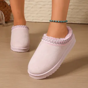 Close-up of pink platform mule slippers with warm faux fur lining and trim.
