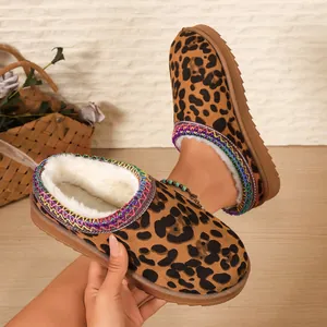 Close-up of leopard print snow boot slippers with colorful braided trim and fur lining