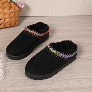 Detail of black platform snow clogs with colorful embroidery and fuzzy warm lining