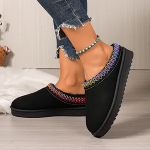 Close-up of black women's slippers with colorful embroidered collar and thick sole