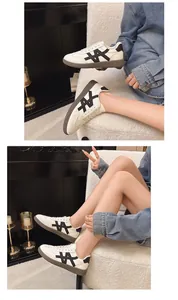 Stylish women's platform white sneakers with black patchwork and brown rubber sole