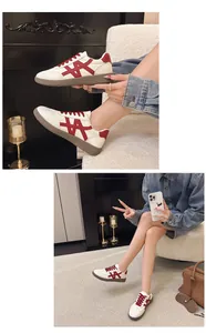 Detail shot of women's thick-sole sneakers with red lace and color-block design.