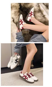 Close-up showing red and black versions of women's platform lace-up sneakers on model