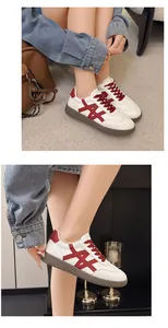 A detailed view showing stylish white sneakers with red accents and thick brown soles.
