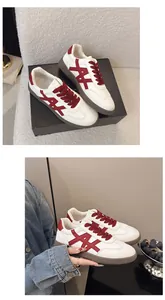 Close-up of white platform sneakers for women with red accents and stylish laces