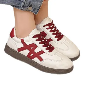 Stylish white platform sneakers with red color-block design and classic lace-up front.