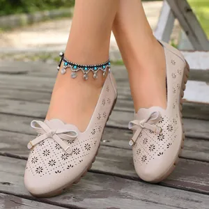 Elegant beige hollow-out leather flat shoes for women with stylish decorative bow detail