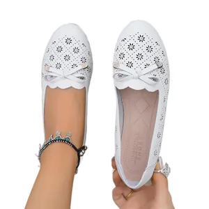 Elegant white laser-cut flat loafers with bow detail for women, comfortable breathable shoes
