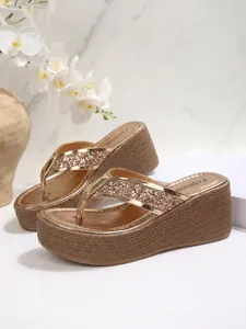 Rose gold platform wedge sandals with glitter straps and woven sole texture detail.