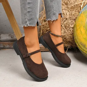 Close-up detail of brown suede Mary Jane shoes featuring a square toe and strap buckle.