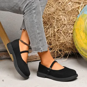 Detailed shot of black suede square toe Mary Jane shoes with buckle strap on model